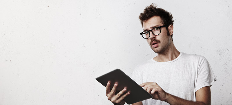 Sceptical guy with tablet