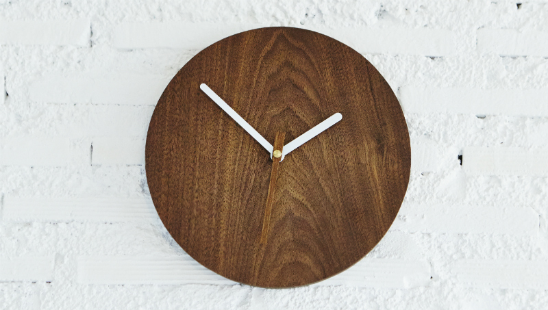 Wooden clock on a white wall