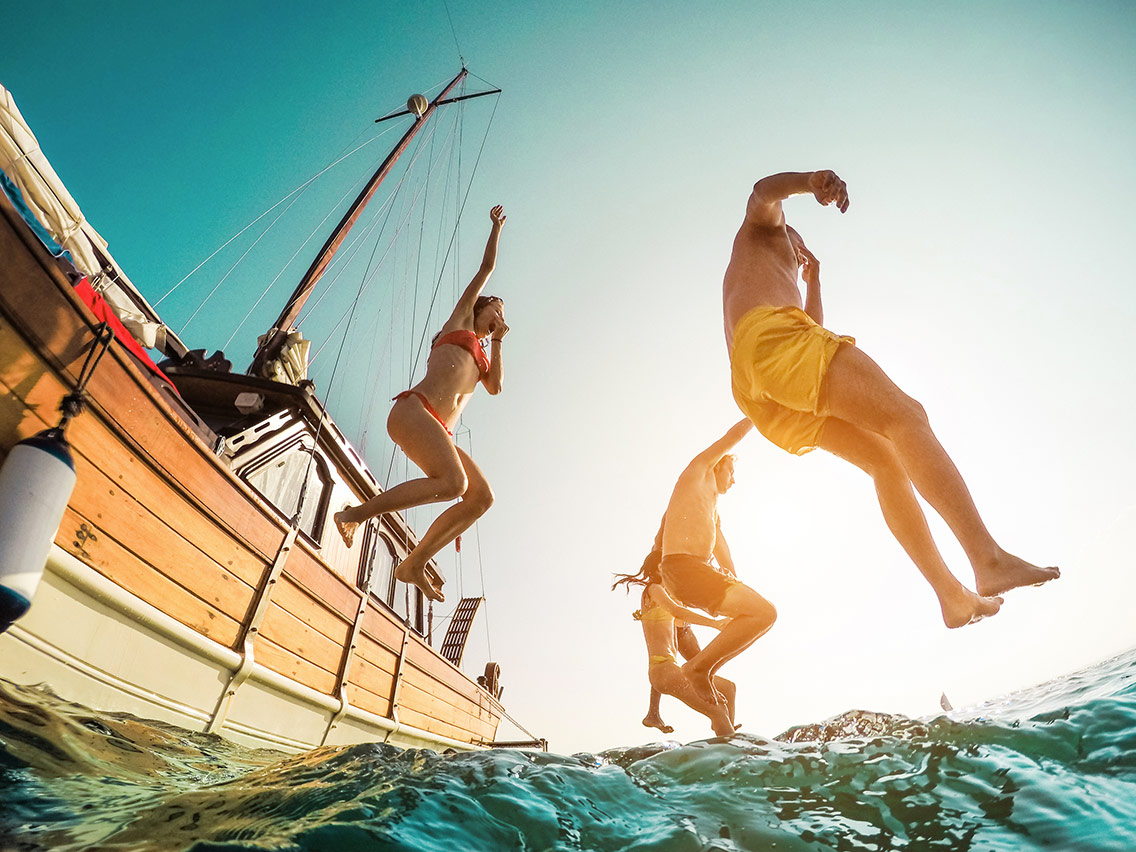 People jumping from a boat
