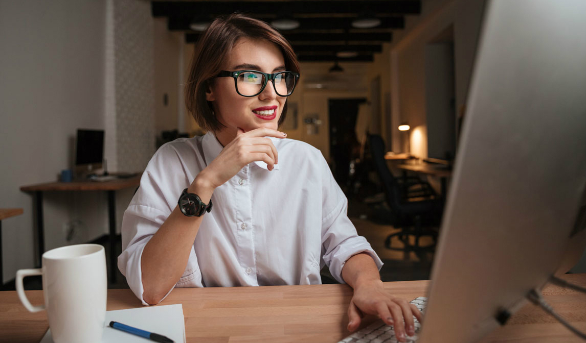 Woman sitting by a computer