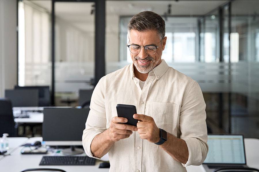 Marketeer watching hiw mobile phone.
