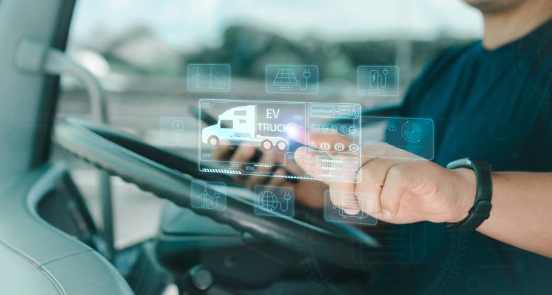 Truckdriver using an app in his truck.