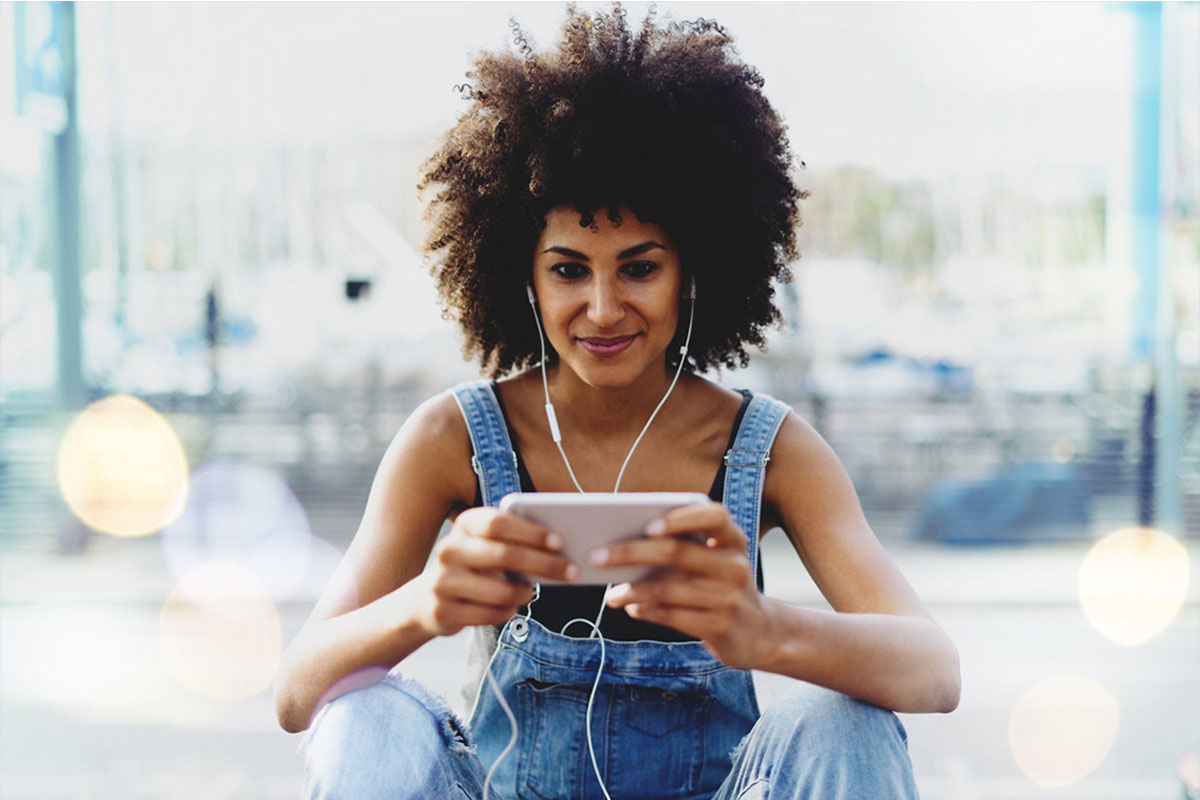 Woman with headphones on her mobile